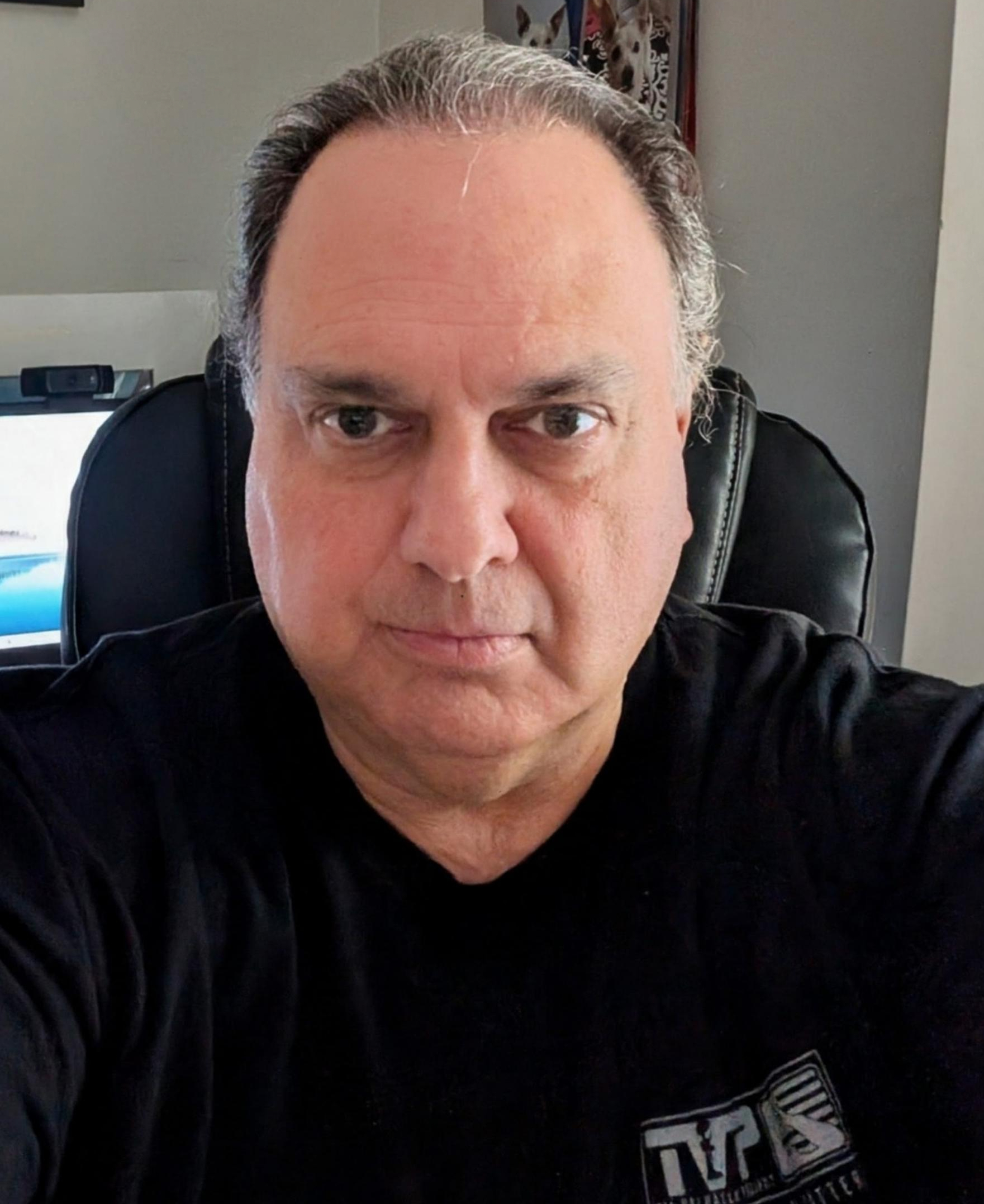 Jay, founder of ScamStomper, at his desk
